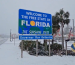 Snow landed at the Welcome to Florida state sign; Courtesy of Meteorologist Bryan Bennett/Instagram